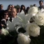 Jonathan Rivers (Michael Keaton) attends a funeral in White Noise (2005).