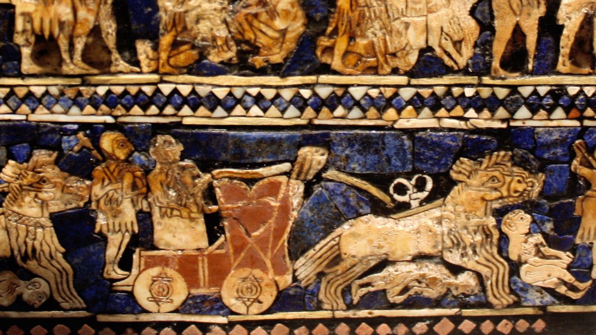 A close-up of an artifact that depicts people riding on a horse-drawn chariot